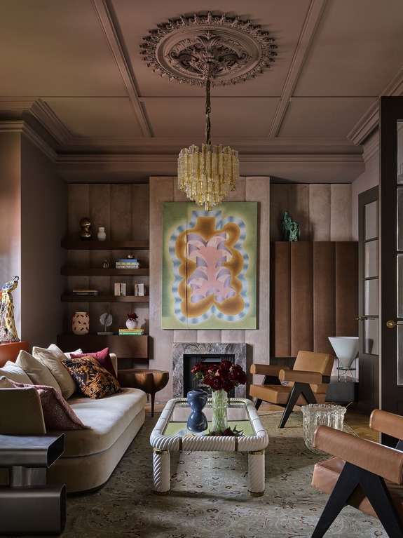 Sophisticated living room with ornate ceiling, modern art, plush furniture, and elegant lighting.