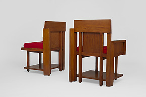 Two wooden armchairs with red cushions, viewed from the back and side on a plain white background.