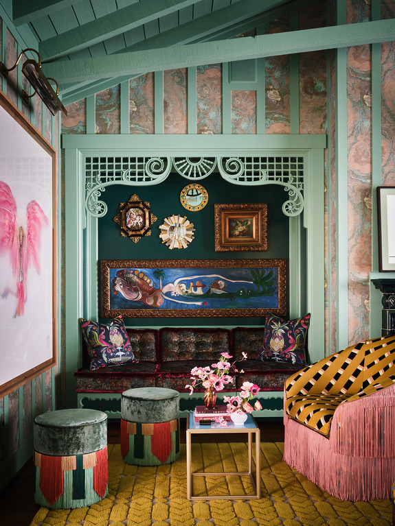Eclectic living room with colorful patterned furniture, wall art, and unique decor in a cozy setting.