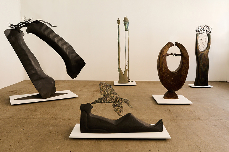 A collection of abstract sculptures on display in an art gallery setting.