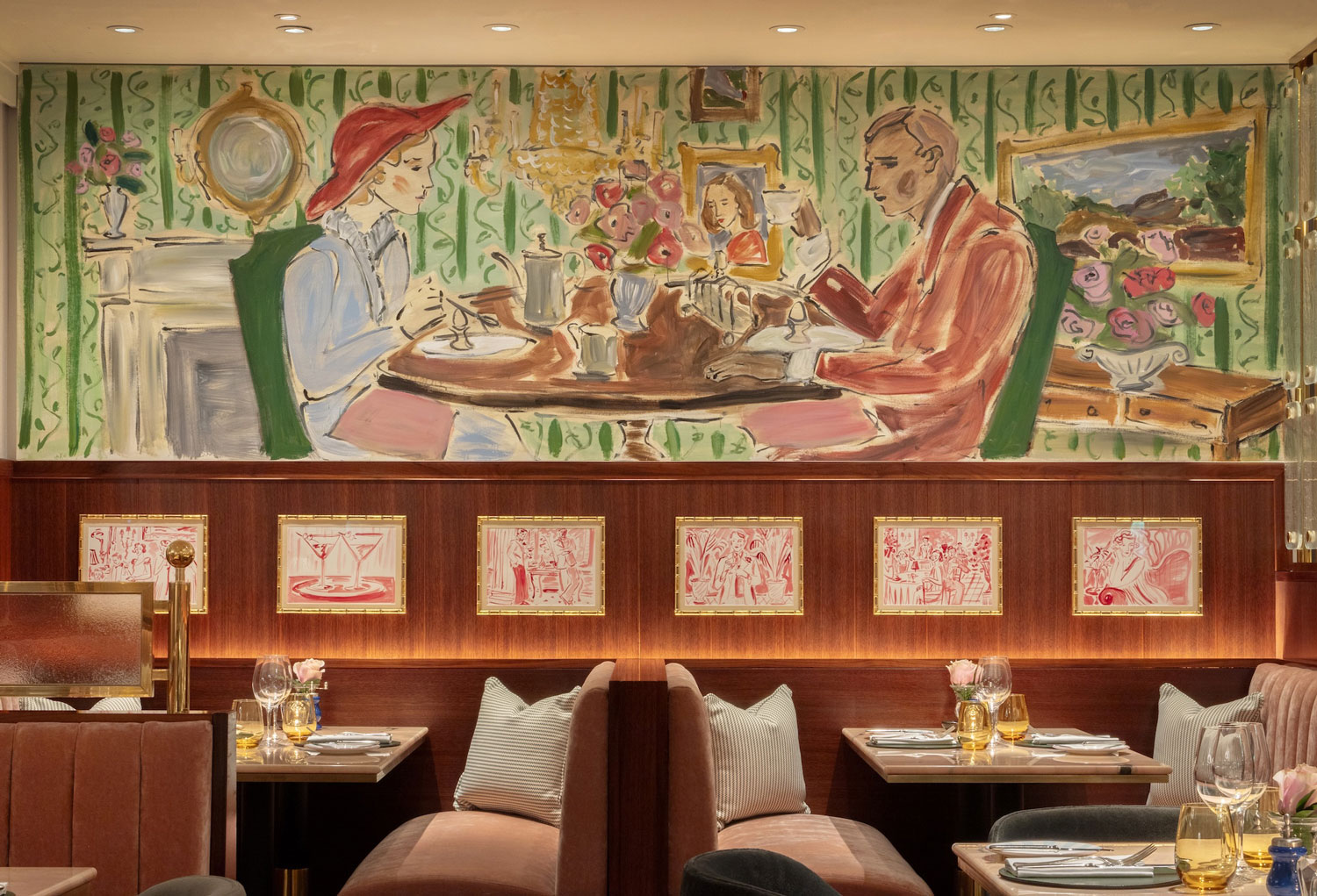 Colorful restaurant interior with paintings, pink roses on tables, and upholstered seating.