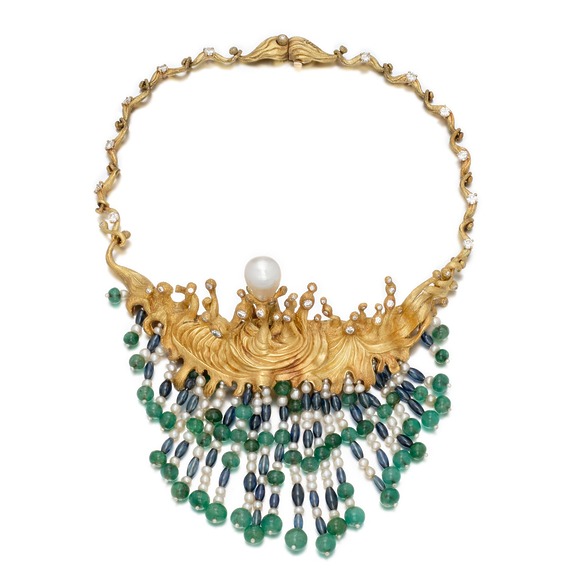 Gold necklace with a wave design, featuring a central pearl and cascading strands of green and blue beads.