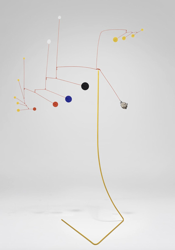 Colorful abstract mobile sculpture with geometric shapes suspended by thin wires on a minimalist stand.