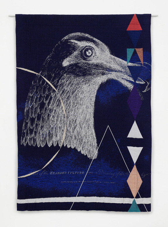 Eagle head illustration on a dark tapestry with colorful geometric shapes and patterns.