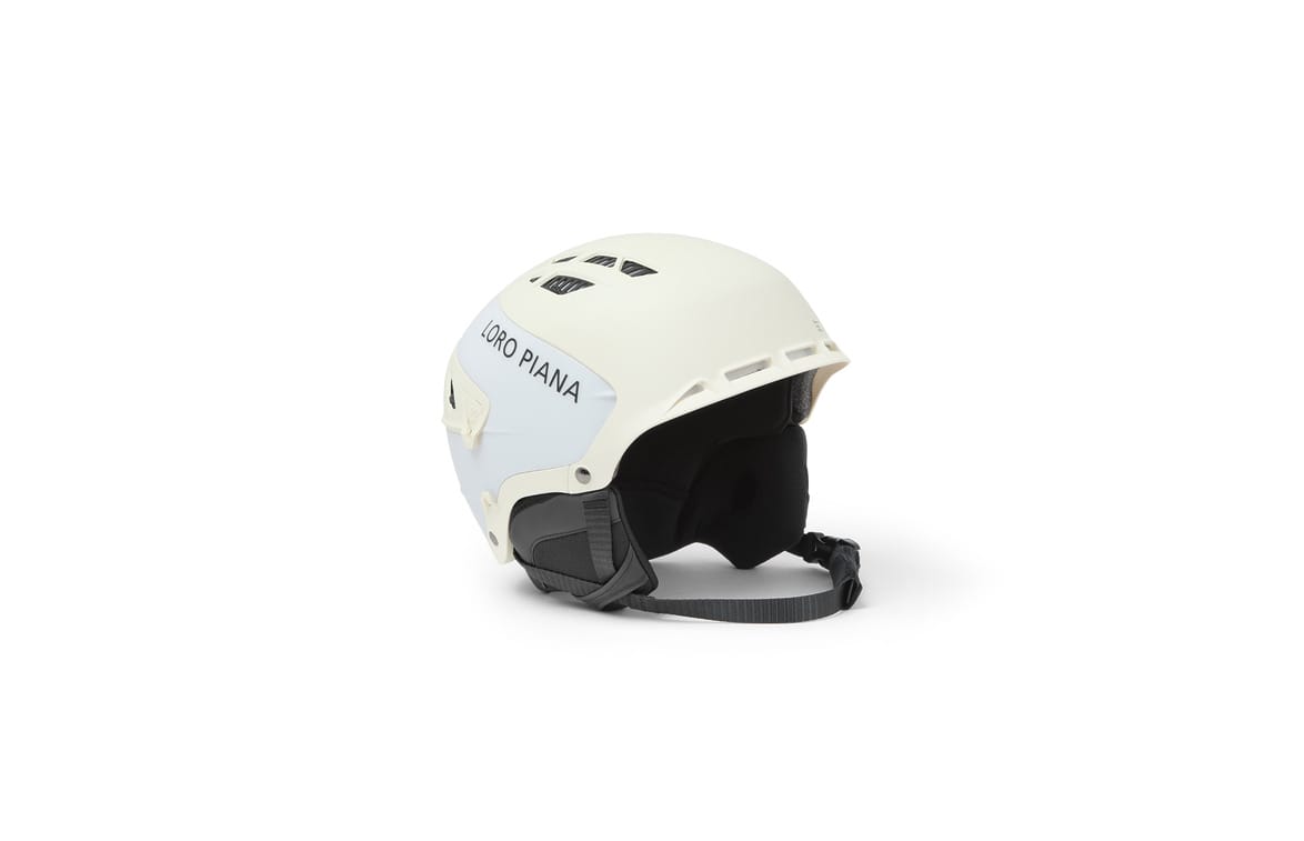 white ski helmet with black padding and adjustable strap