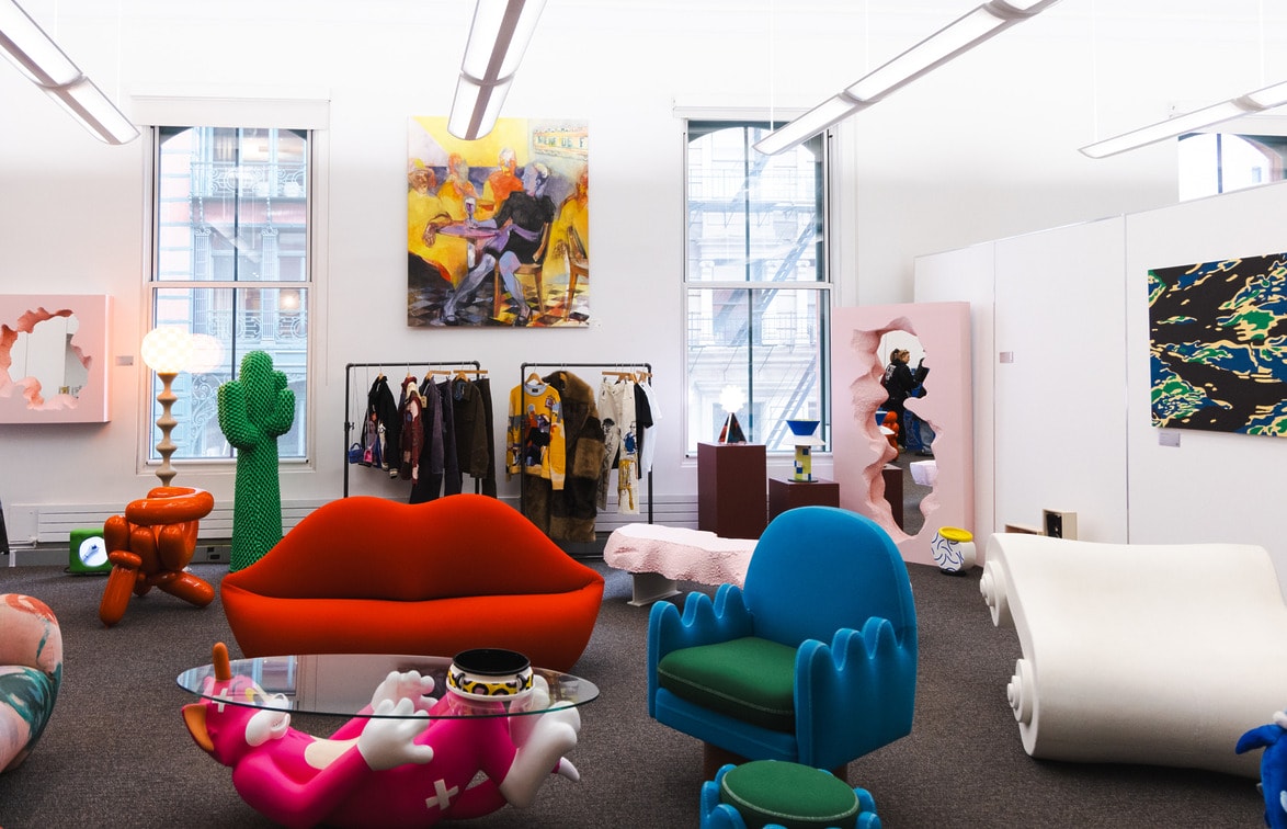Colorful modern office space with unique furniture, art pieces, and large windows.