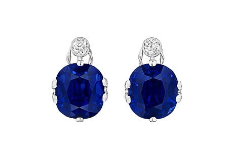 Elegant silver earrings featuring large blue gemstones and small round diamonds.