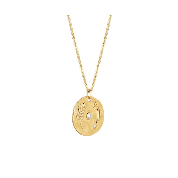 Gold pendant necklace with engraved leaf design and small gemstone accents on a delicate chain.