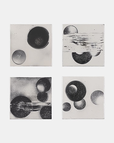 Four abstract black and white artworks with circle and swirl patterns displayed in a grid format.
