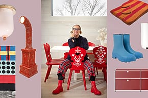 Person sitting on a red chair with colorful decor items including boots, rugs, and a light fixture displayed around them.