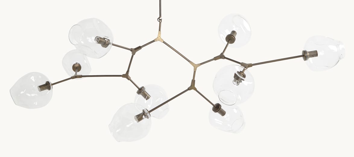 Modern chandelier with multiple clear glass globes and a minimalist metal frame against a white background.