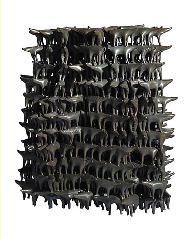 Abstract bronze sculpture with multiple interlocking animal-like shapes, creating a complex three-dimensional geometric pattern
