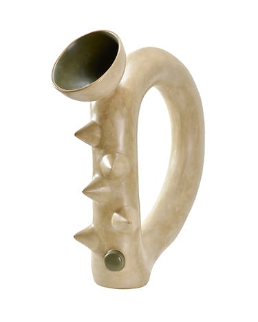 Unique beige ceramic vase with a curved handle, spiky texture along the body, and a tilted round opening at the top.