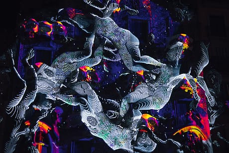 Abstract digital art with vibrant colors and swirling patterns against a dark background, creating a dynamic visual effect.