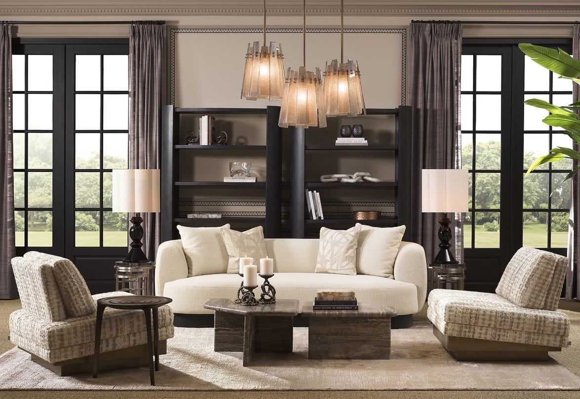 Elegant living room with modern furniture, plush sofas, stylish lighting, large windows, and lush greenery outside.