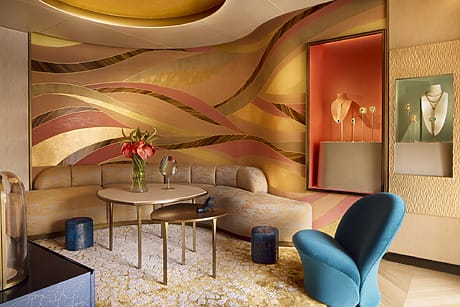 Luxurious jewelry showroom with decorative walls, plush seating, and elegant displays.