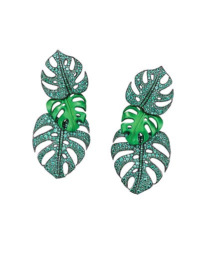 Green monstera leaf earrings with intricate detailing and sparkling accents on a white background.