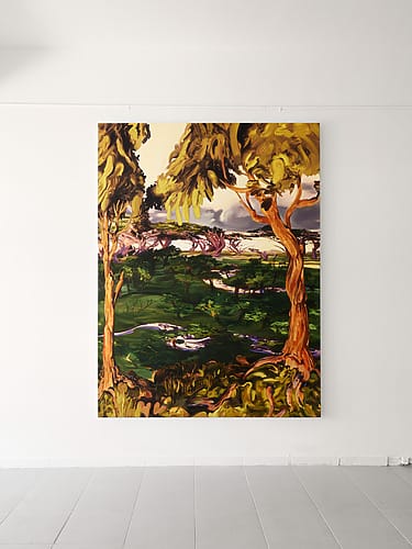 Large colorful landscape painting featuring trees and greenery displayed on a white gallery wall.