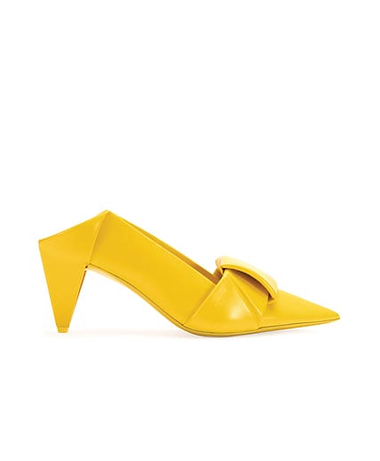 Yellow high-heeled shoe with geometric design and large buckle on the side.