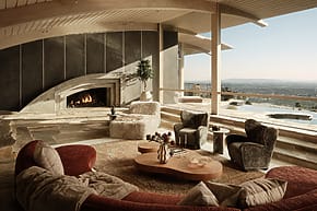 Spacious living room with modern fireplace, curved couches, plush chairs, wooden ceiling, and panoramic city view.