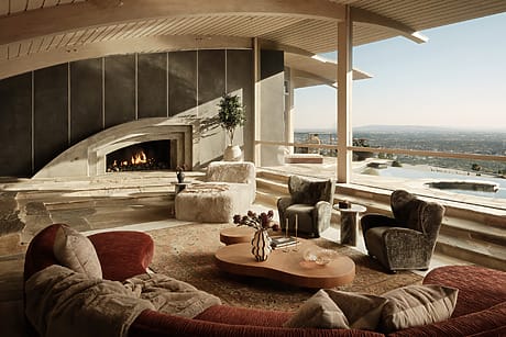Spacious living room with modern fireplace, curved couches, plush chairs, wooden ceiling, and panoramic city view.