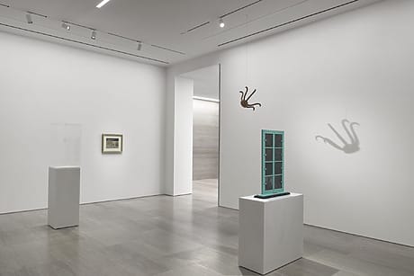 Gagosian gallery interior with Marcel Duchamp sculptures and prints displayed on white walls and pedestals.