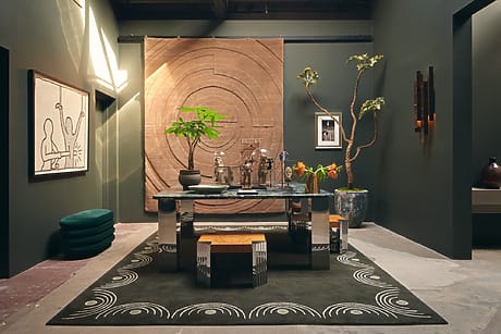 Stylish modern dining room with abstract art, green walls, wooden accents, and elegant decor pieces.