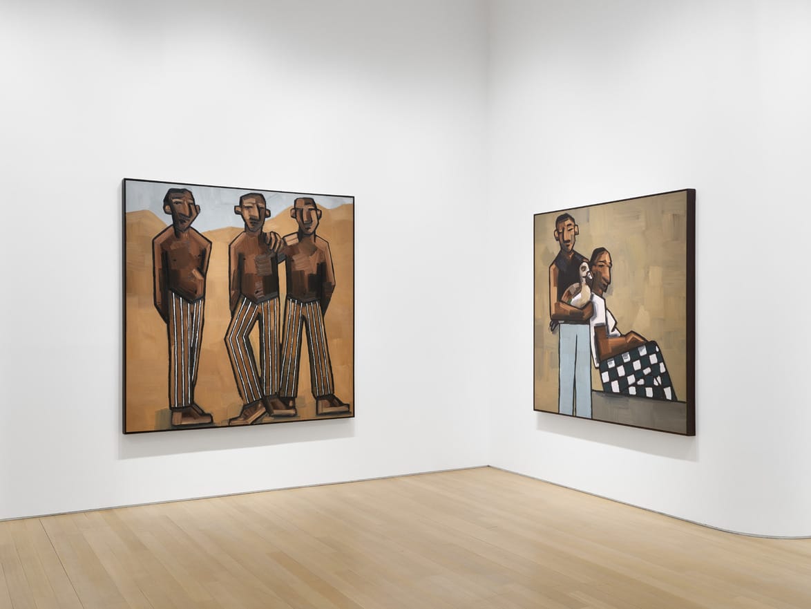 Art gallery room with two paintings depicting abstract human figures on white walls and wooden floor.