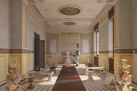 Historic room with ornate ceiling, decorative walls, and an array of unique sculptures and geometric designs on the floor.