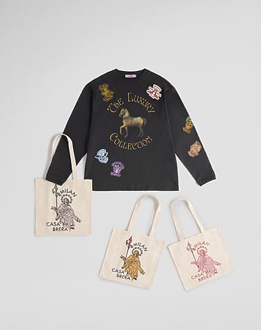 Black long-sleeve shirt with a horse design and three beige tote bags featuring artistic prints displayed on a gray background.