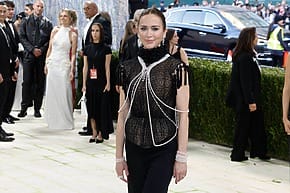 Emily Blunt in a black lace top with Mikimoto pearls, on the red carpet at the 2026 Met Gala.