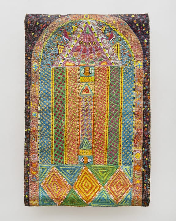 Colorful geometric textile art with intricate patterns, featuring vibrant triangles, squares, and circular motifs.