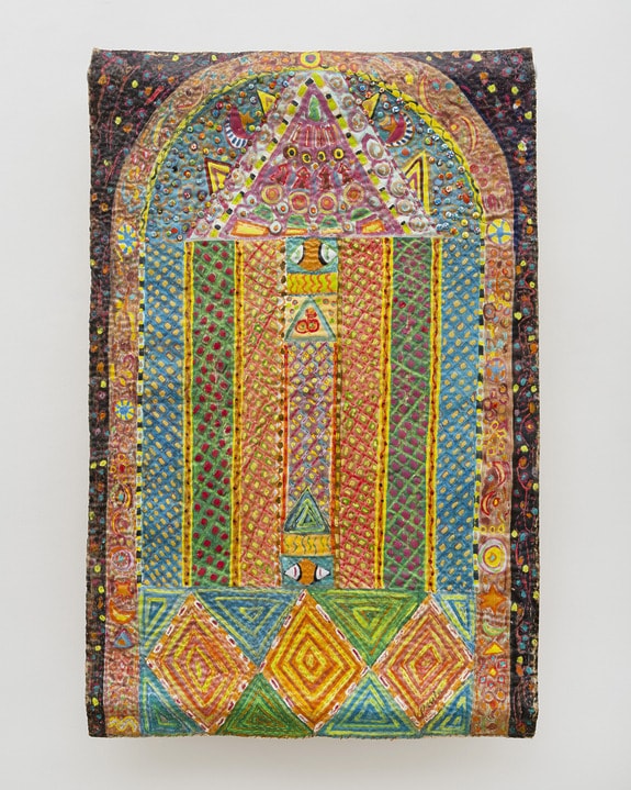 Colorful geometric textile art with intricate patterns, featuring vibrant triangles, squares, and circular motifs.