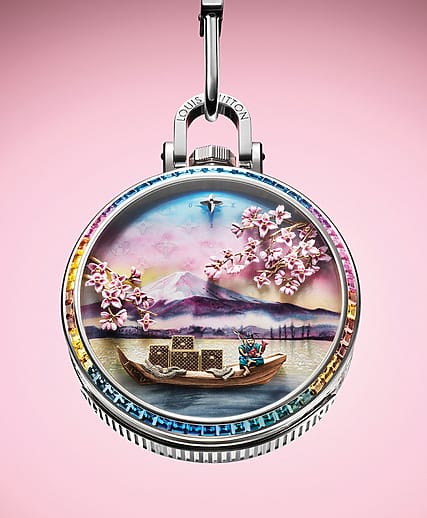 Luxury watch with cherry blossoms, boat, and mountain scene on a pink background.