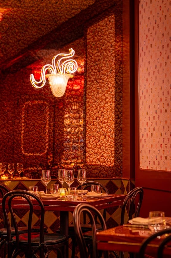 Cozy restaurant setting with elegantly arranged dining table, chairs, and ambient lighting.